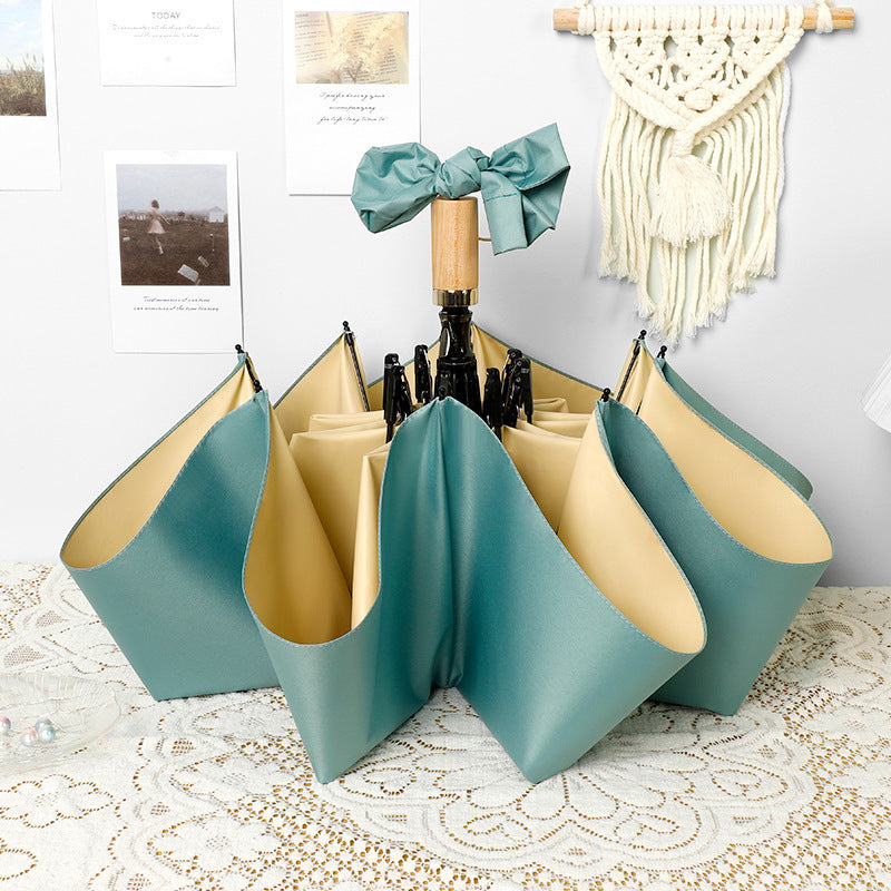 Ladies elegant folding umbrella in portrait format with stylish wooden handle Bowlift