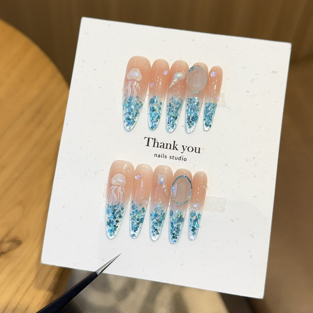 Creative artificial nails with maritime designs and sparkling accents Bowlift