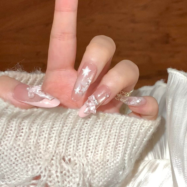 Artificial nail tips with glamorous glitter and bow details Bowlift