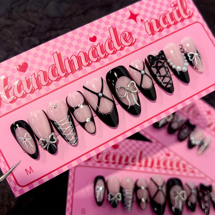 Artful nail art with elegant bows and glitter accents Bowlift