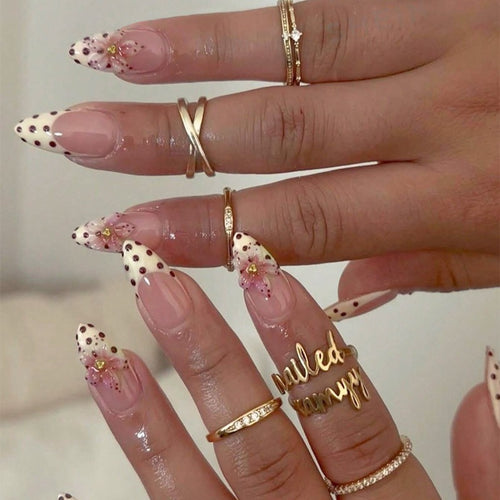 Acrylic nail set with romantic dots and floral accents Bowlift