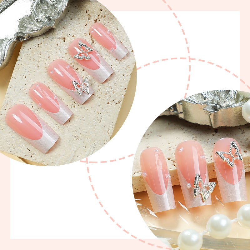 Nail art set with intricate designs and butterfly appliqués Bowlift