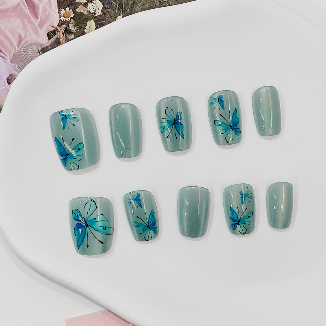Artistic acrylic nails with butterfly motif Bowlift