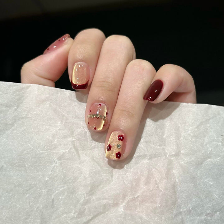 Artificial nails in luxurious glamour design with floral and glittering accents Bowlift