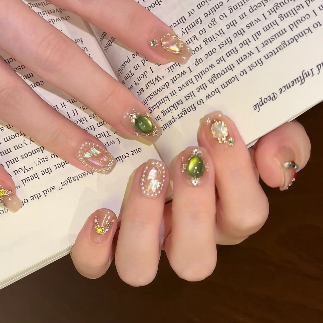 Artificial nails with rhinestone and pearl accents Bowlift
