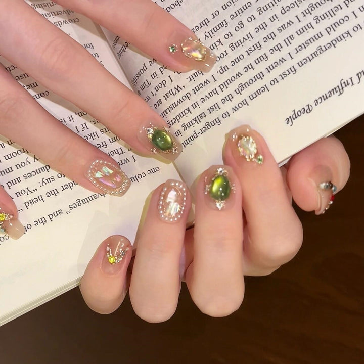 Artificial nails with rhinestone and pearl accents Bowlift