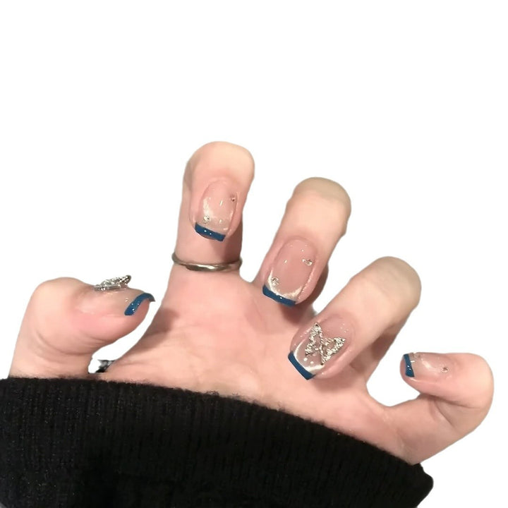 Artificial nails with trendy French tips and decorative glitter accents Bowlift