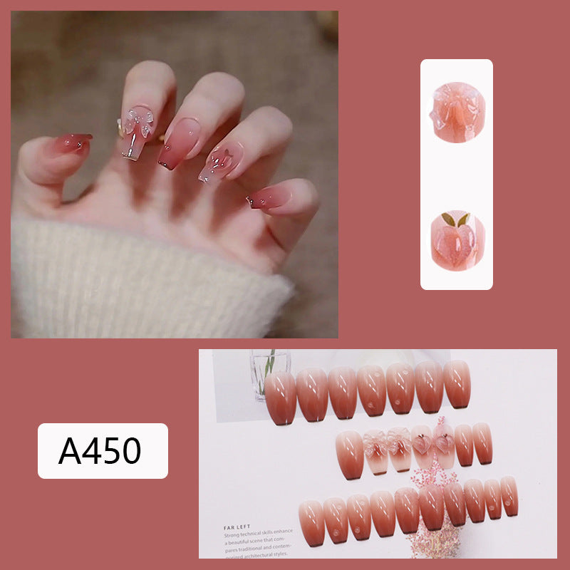Glamorous artificial nails with heart design and glittering accents Bowlift