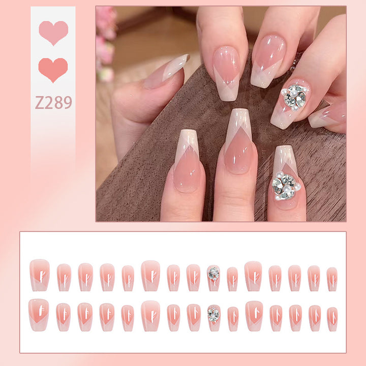 Artificial nail set with filigree tip designs and glamorous rhinestone accents Bowlift