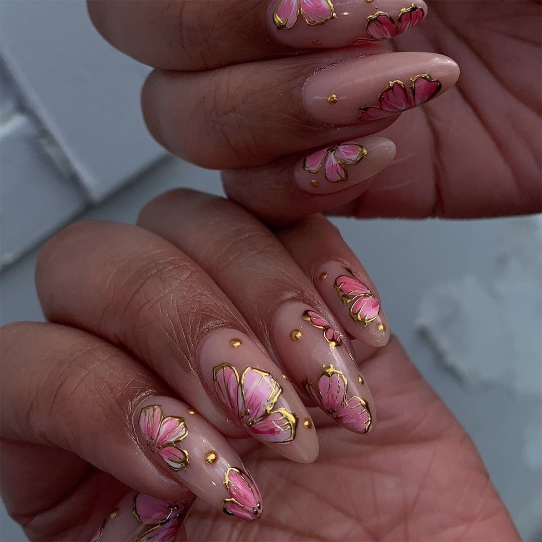 Artful nail art with elegant floral designs and gold accents Bowlift