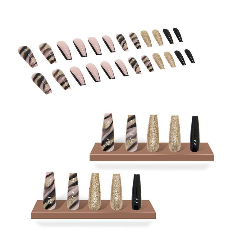 Acrylic nail set with luxurious golden accents and elegant designs Bowlift