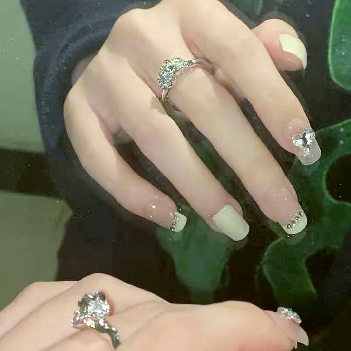 Glamorous artificial nails with heart and rhinestone decorations Bowlift