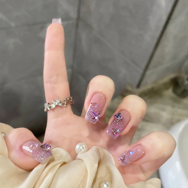 Glamorous artificial nails with glitter and floral accents Bowlift