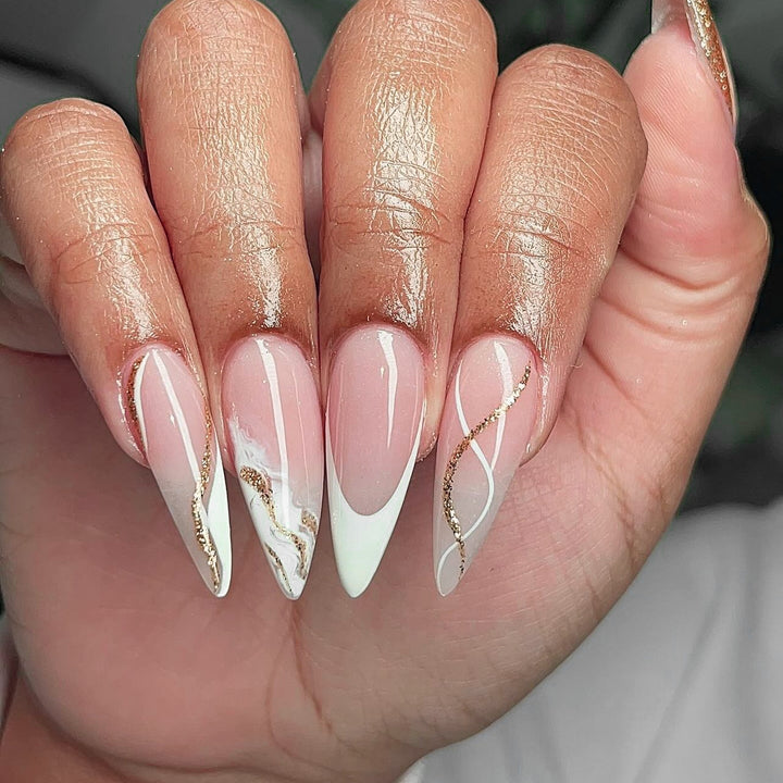 Artful stiletto nails with elegant marble and glitter design Bowlift