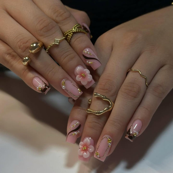 Artificial nail art with flower and glitter effects Bowlift