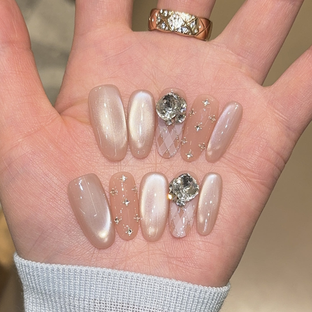 Elegant artificial nails with shimmering effects and rhinestone accents Bowlift