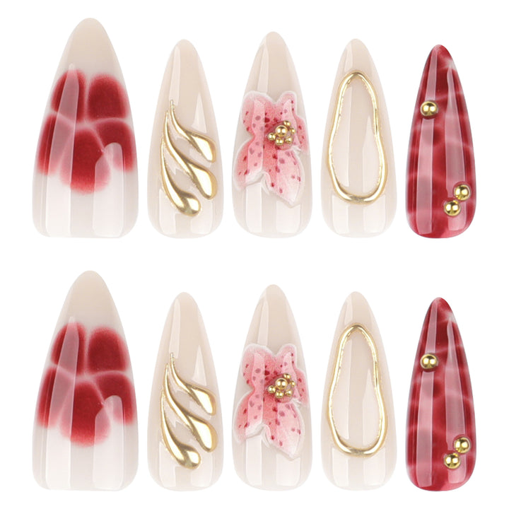 Artful stiletto nails with elegant floral designs and glitter accents Bowlift