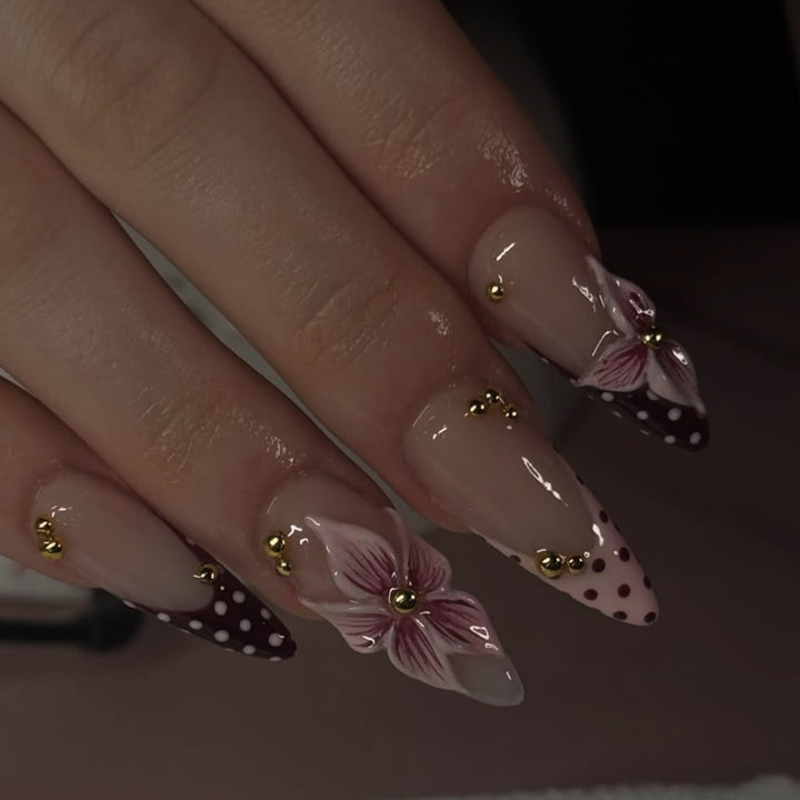 Artful stiletto nails with floral accents and glitter Bowlift