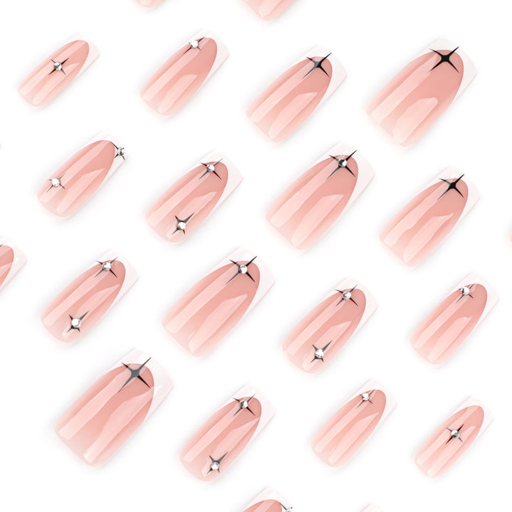 Artificial nail extensions with elegant French tip and glitter accents Bowlift