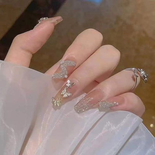 Artificial nails with sparkling rhinestone and bow accents Bowlift