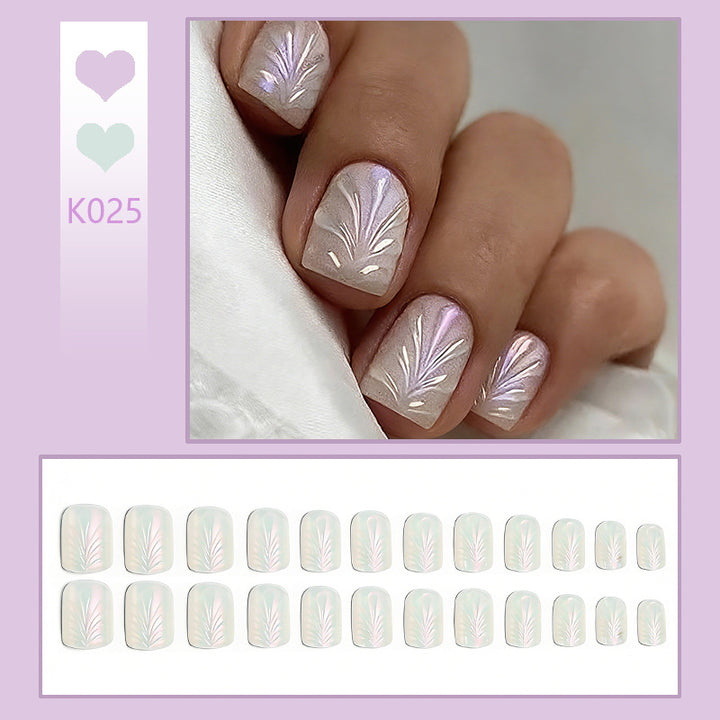 Acrylic nail set with elegant pearl details and fine floral patterns Bowlift