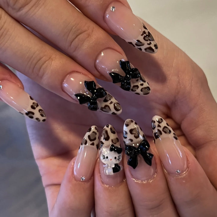 Artistic extension nails in leopard pattern with bow accents Bowlift