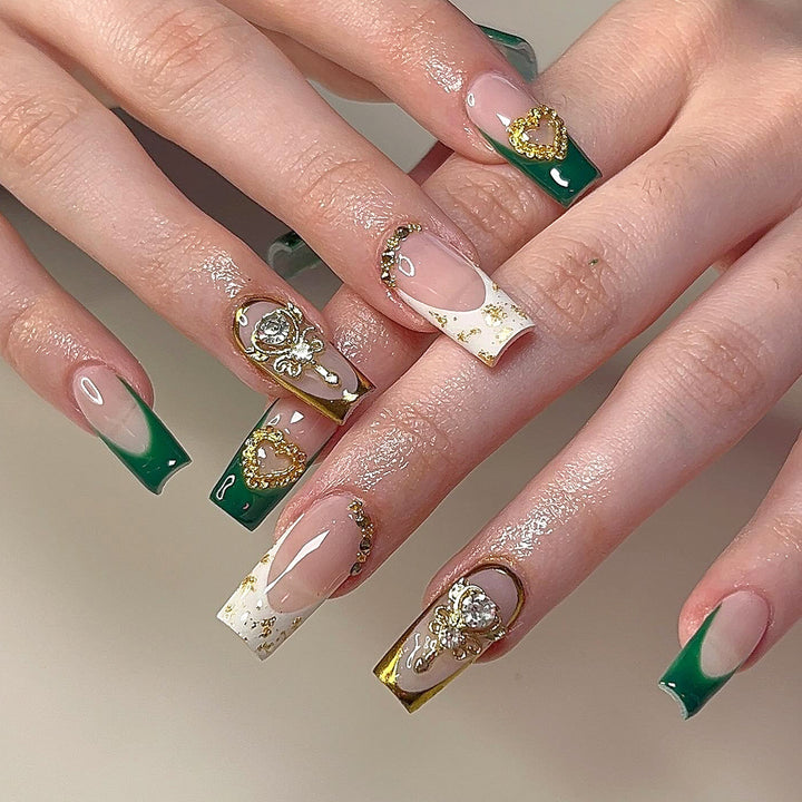 Exquisite artificial nails with gold embellishments and glitter accents Bowlift