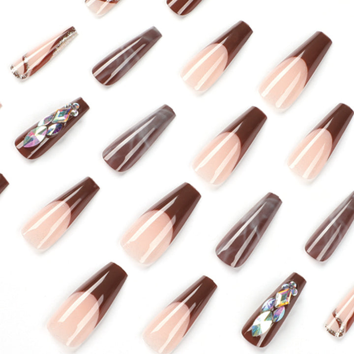 Artificial nail extensions with elegant gemstone embellishments Bowlift