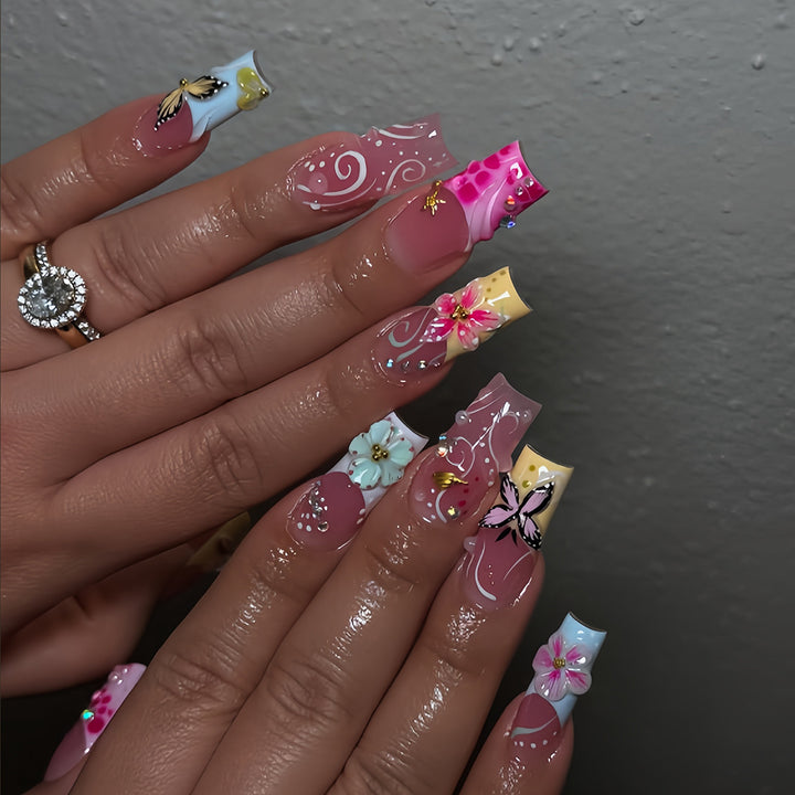 Artistic nails with floral accents and glitter clusters Bowlift