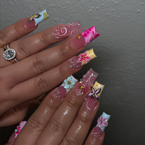 Artistic nails with floral accents and glitter clusters Bowlift