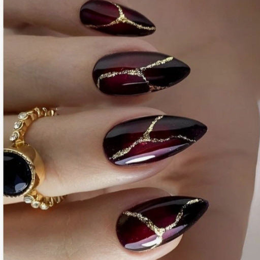 Artistic Press-On Nail Design with Gold Veining Accents Bowlift