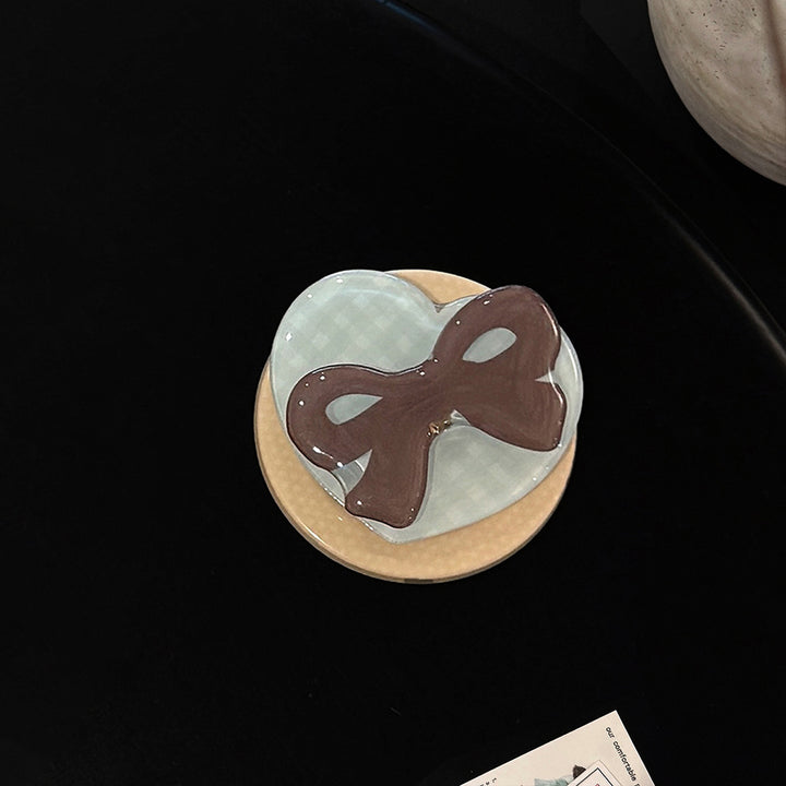 Decorative ceramic coaster with bow motif Bowlift