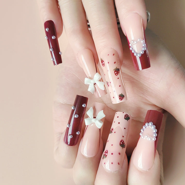 Artificial artificial nails with heart designs and holographic accents Bowlift