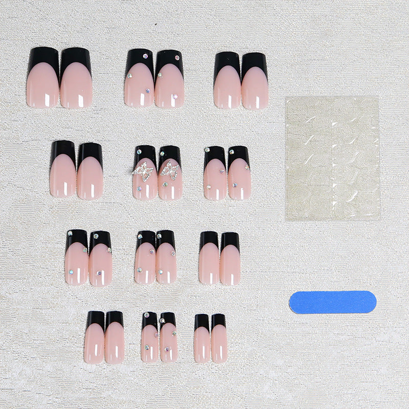 Acrylic nail set with elegant black and white design and glitter accents Bowlift