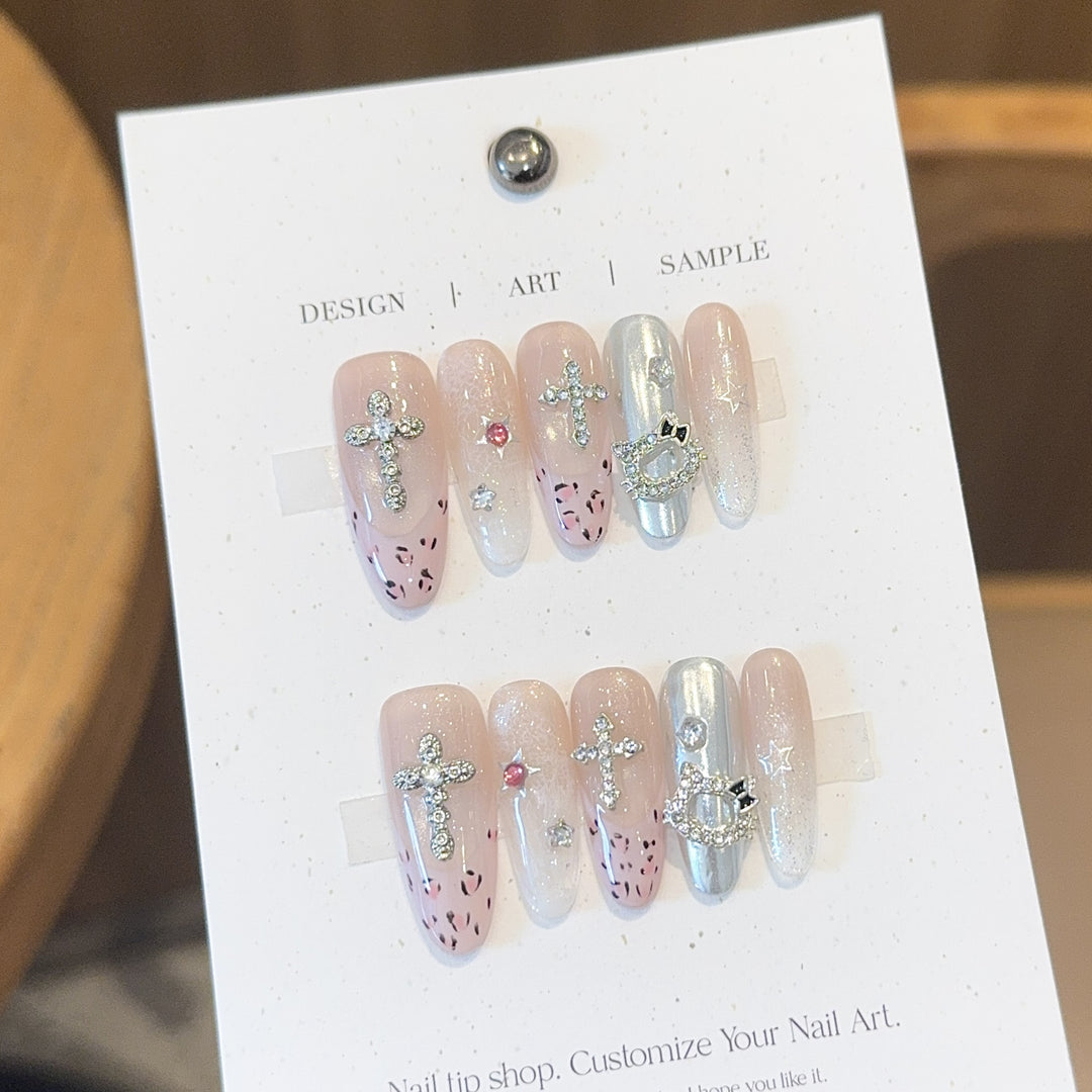 Artificial nails with sparkling rhinestones and cross motifs Bowlift