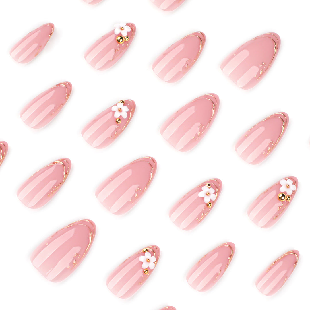 Artful nail design with golden accents and floral details Bowlift