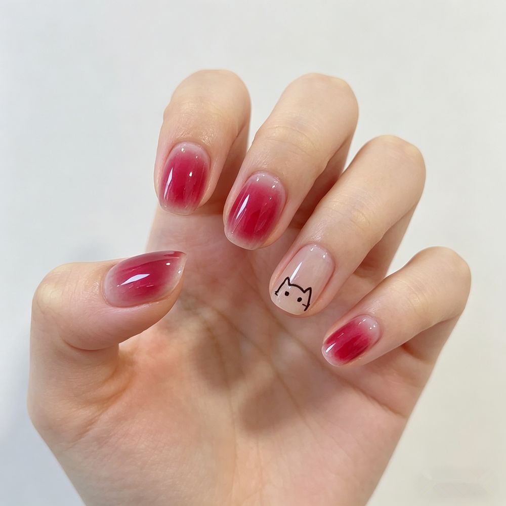 Artificial nails with elegant ombre effect and playful cat design Bowlift