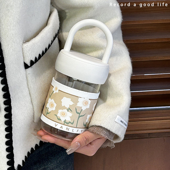 Women's insulated drinking bottle with ergonomic carrying handle and elegant flower design Bowlift