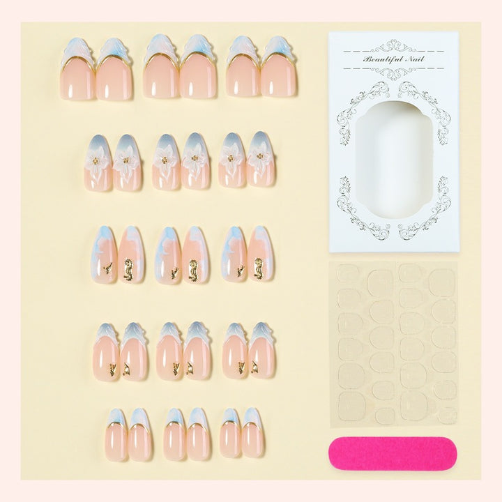 Creative nail set with elegant gold embellishments Bowlift