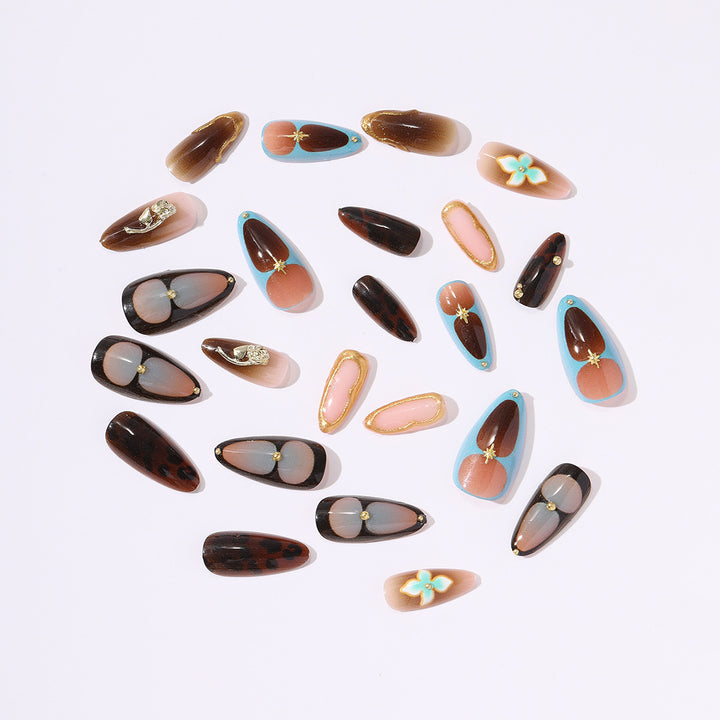 Artificial nail set with luxurious gold design and floral accents Bowlift