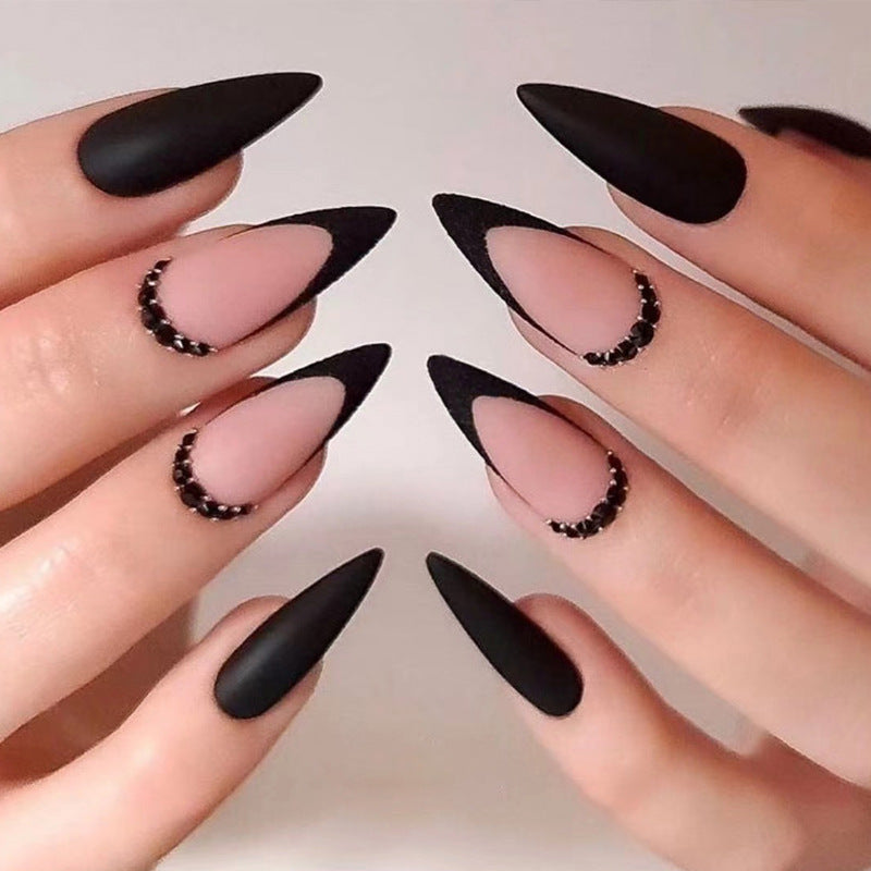 Artful stiletto nails with elegant black design and glitter accents Bowlift