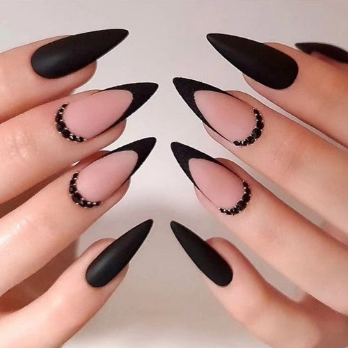 Artful stiletto nails with elegant black design and glitter accents Bowlift