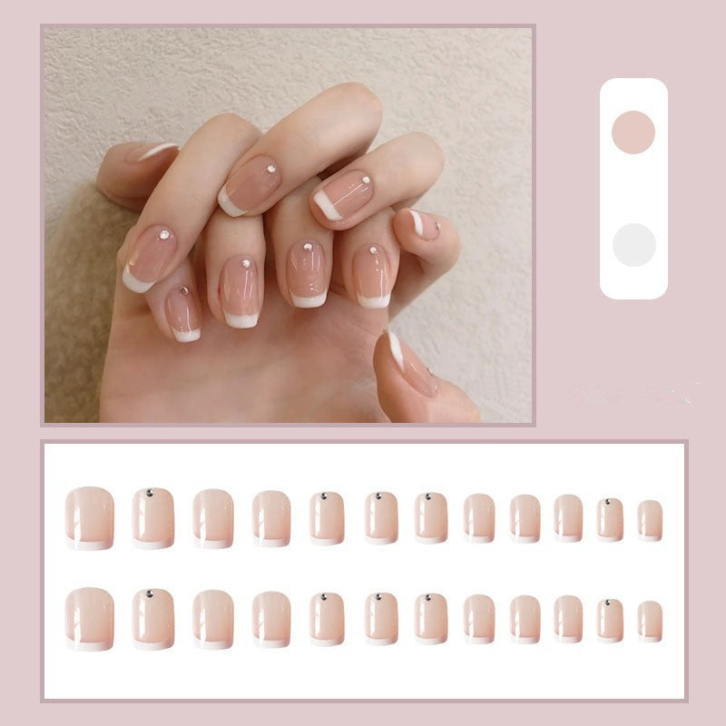 Artificial nails with elegant French tip and rhinestone accents Bowlift