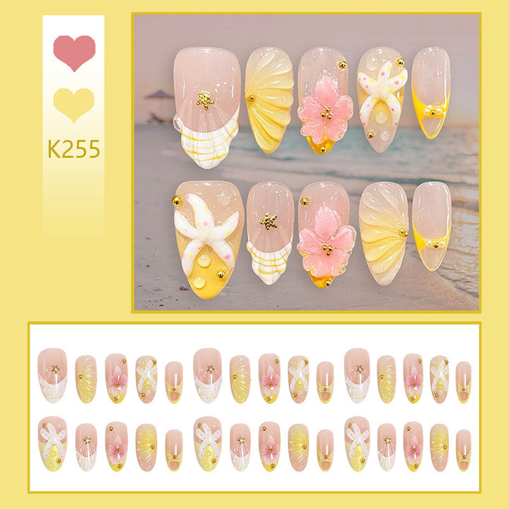 Artificial nail set with glamorous floral designs and creative glitter accents Bowlift