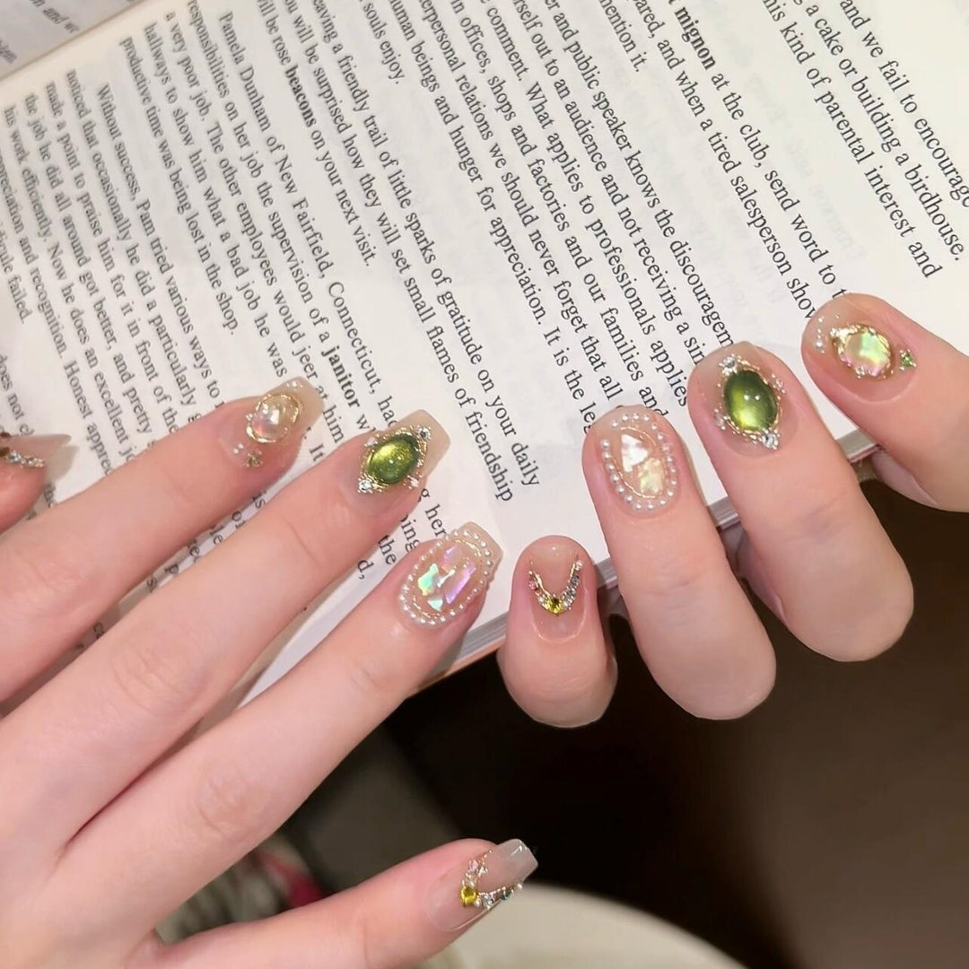 Artificial nails with rhinestone and pearl accents Bowlift