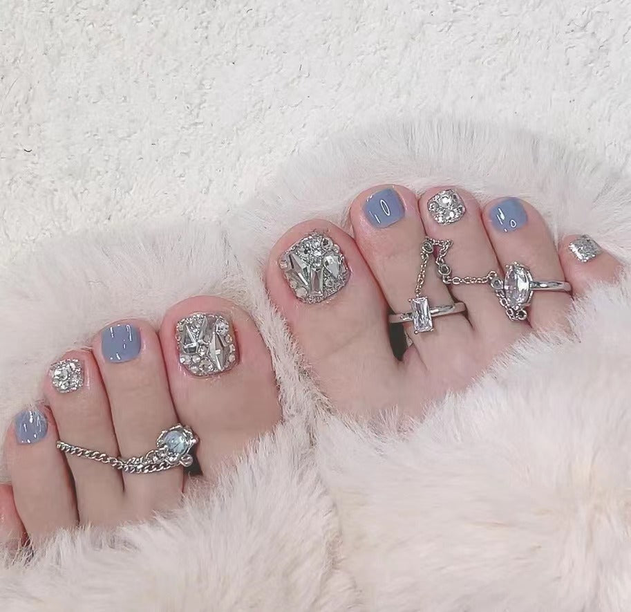 Artistic toenail art with rhinestone and glitter elements Bowlift