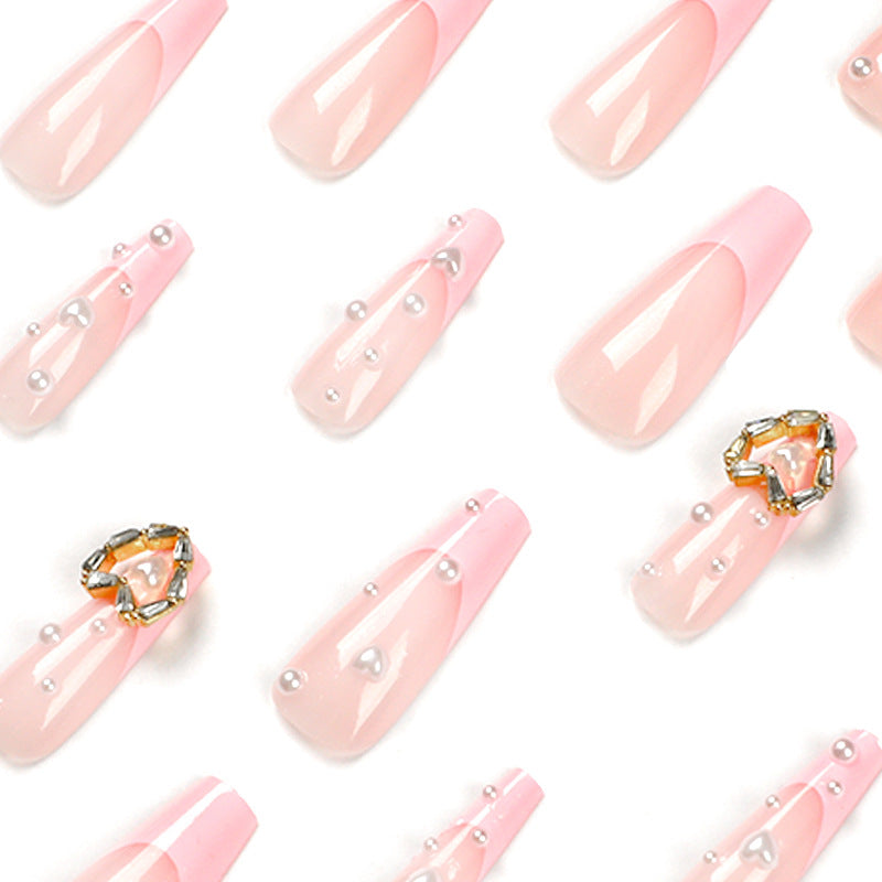Artistic nail art with heart and pearl accents Bowlift