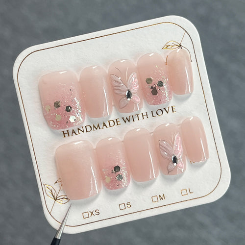 Artful nail art with butterfly designs and glitter accents Bowlift