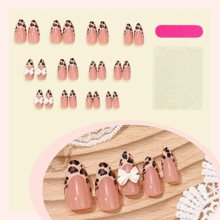 Artificial nail set with elegant leopard design and playful bow accents Bowlift