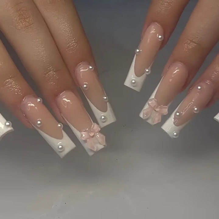 Artistic nail extensions with pearls and bows decorations Bowlift
